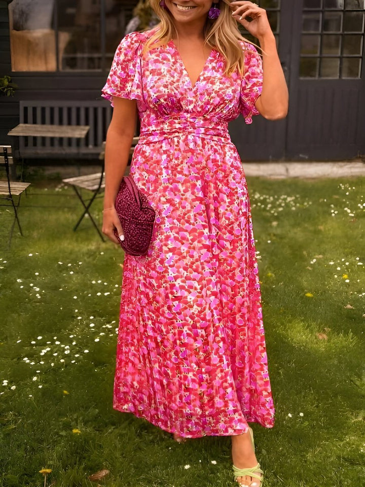 Full length view of floral pleated maxi dress styled for summer parties and events