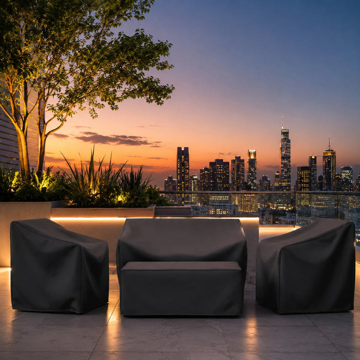 Outdoor lounge furniture set covered with protective shield at night