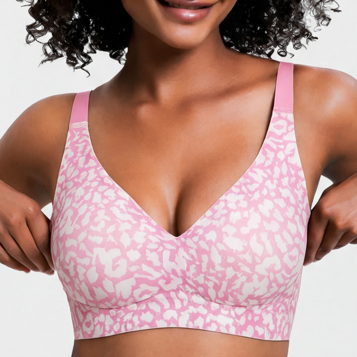 Model wearing a pink wireless deep v comfort bra with printed pattern