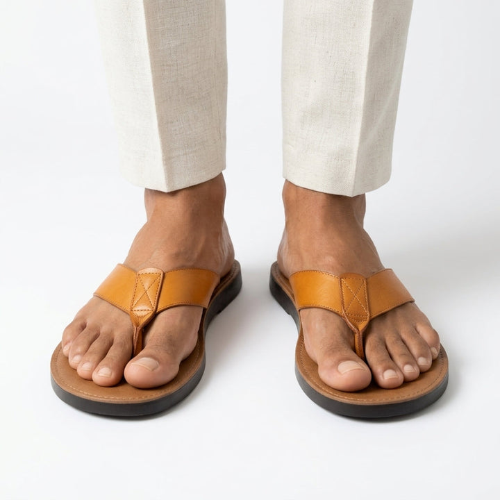Close-up of orange Sebastian Sandals worn with light trousers