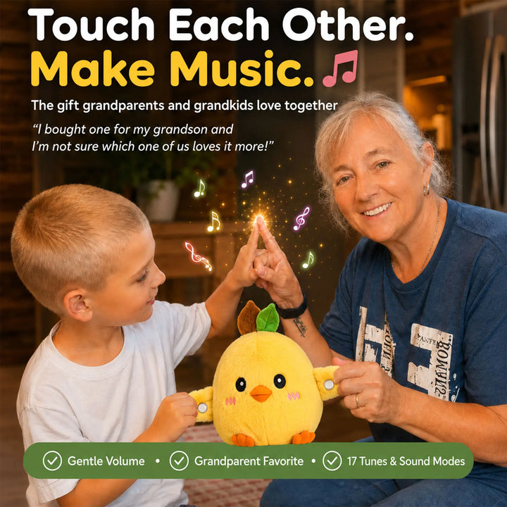A young boy and an older woman holding hands to activate the musical sensory toy while smiling together.