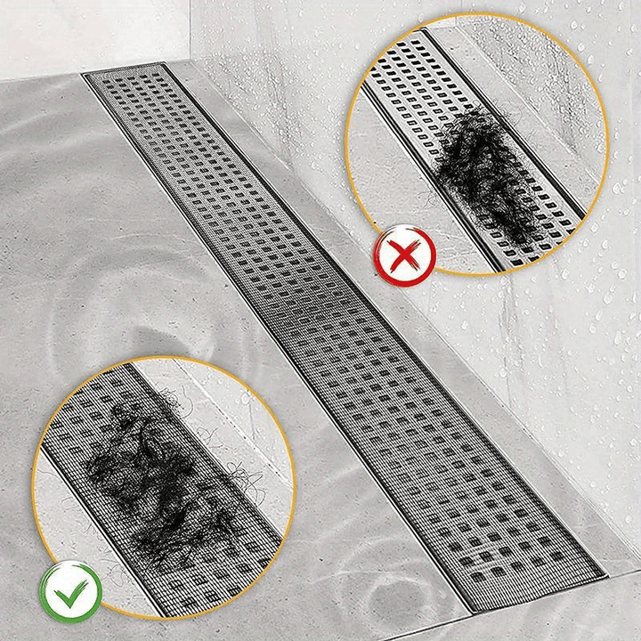 Drain protection mesh installed over a long shower floor drain catching debris
