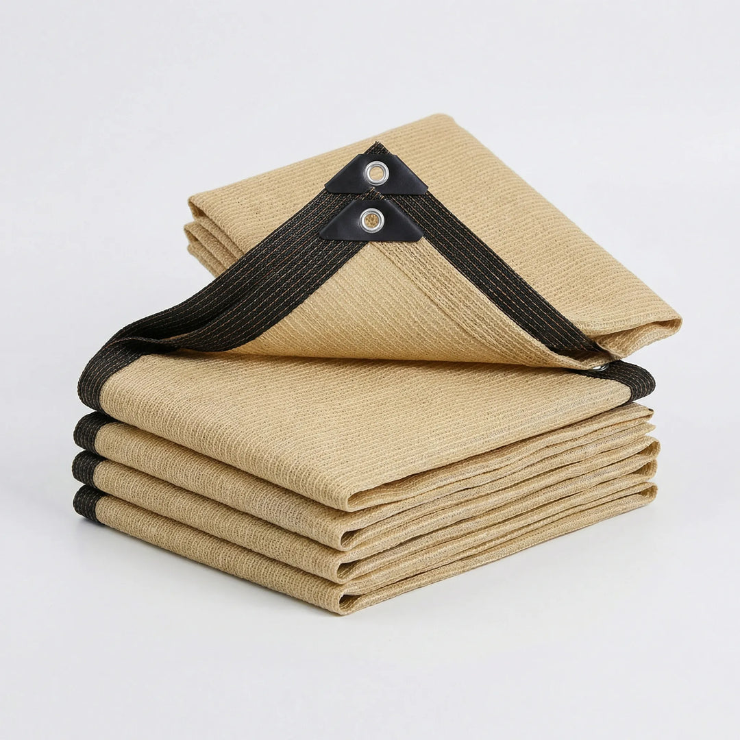 Folded beige rectangular sunshade awning showing reinforced corner eyelets
