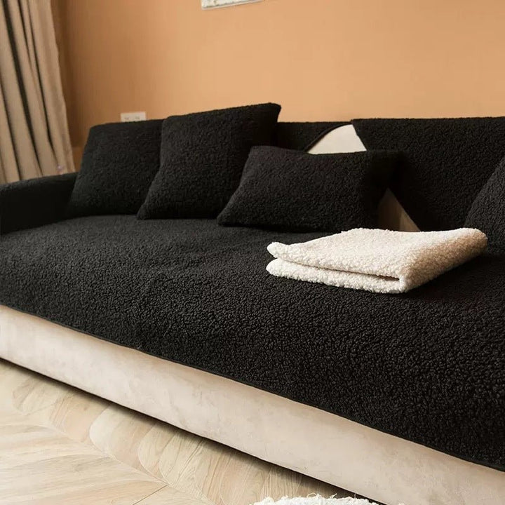 Black plush sofa cover elegantly displayed on a living room couch with a white blanket