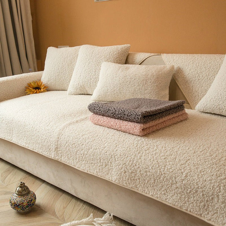 Beige plush sofa cover draped nicely over a living room couch with matching throw pillows