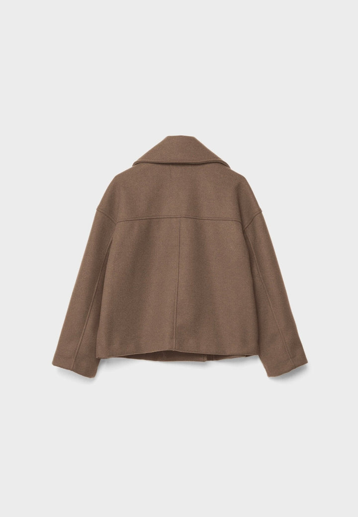Sleek cropped winter jacket complementing various casual outfits