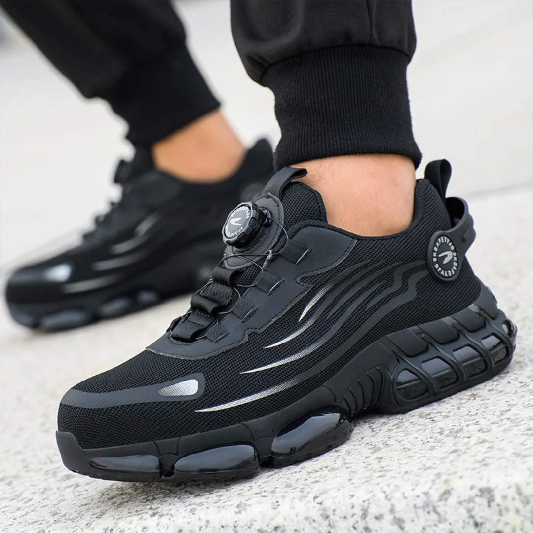 Close-up of men's black safety work shoes worn outdoors on concrete