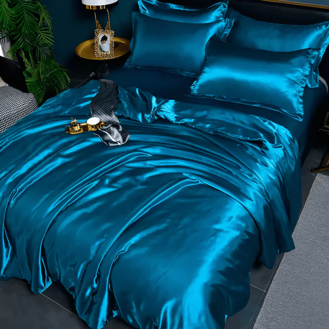Luxurious vibrant blue silk-look bedding set neatly arranged on a modern bed