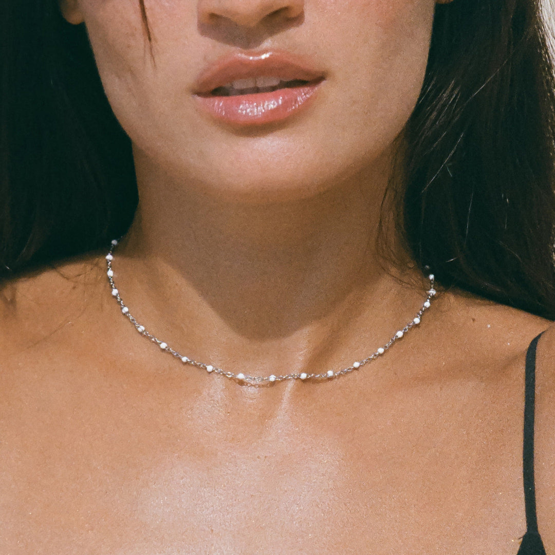 Complete view of the white enamel bead choker necklace on display