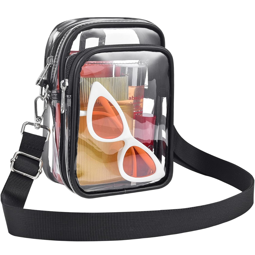 Black trim clear crossbody handbag with adjustable strap and accessories inside