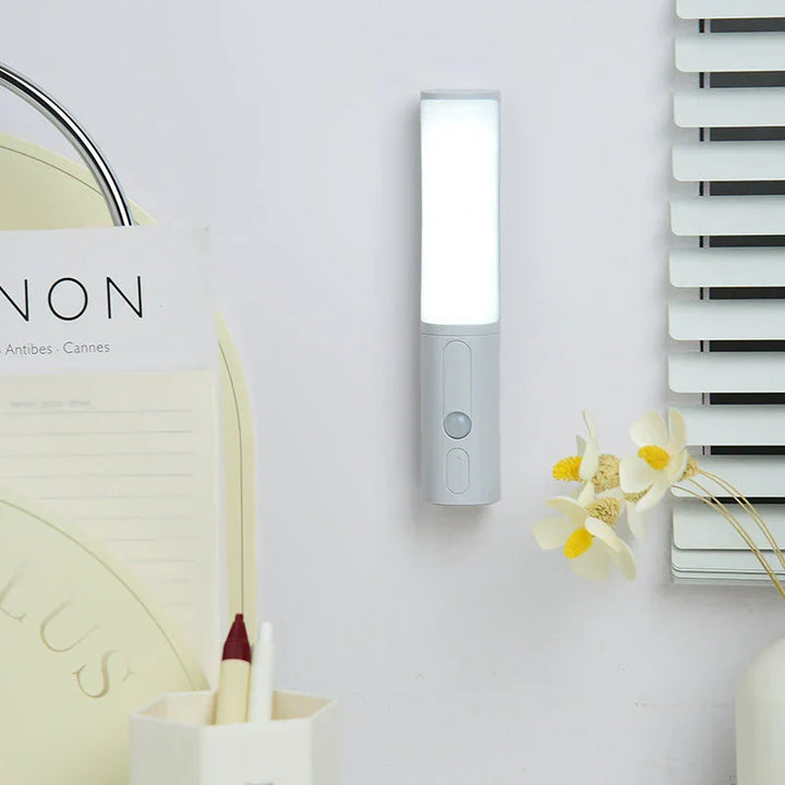 Smart LED Night Light with Motion Sensor mounted on a wall next to decor