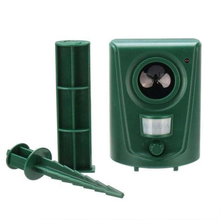 Waterproof outdoor repellent unit installed near flowers for safe animal deterrent