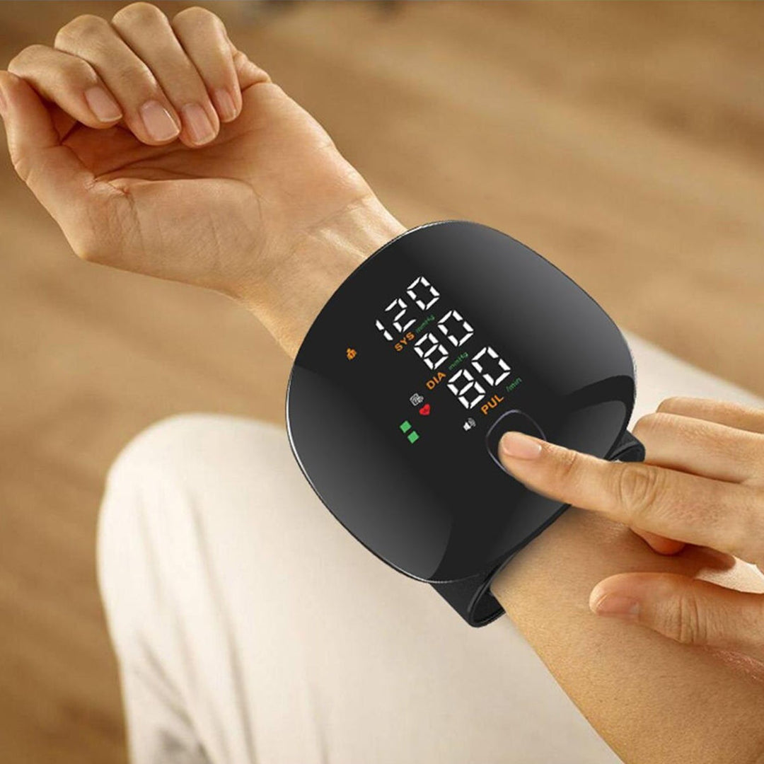 Smart wrist blood pressure monitor displaying readings on wrist