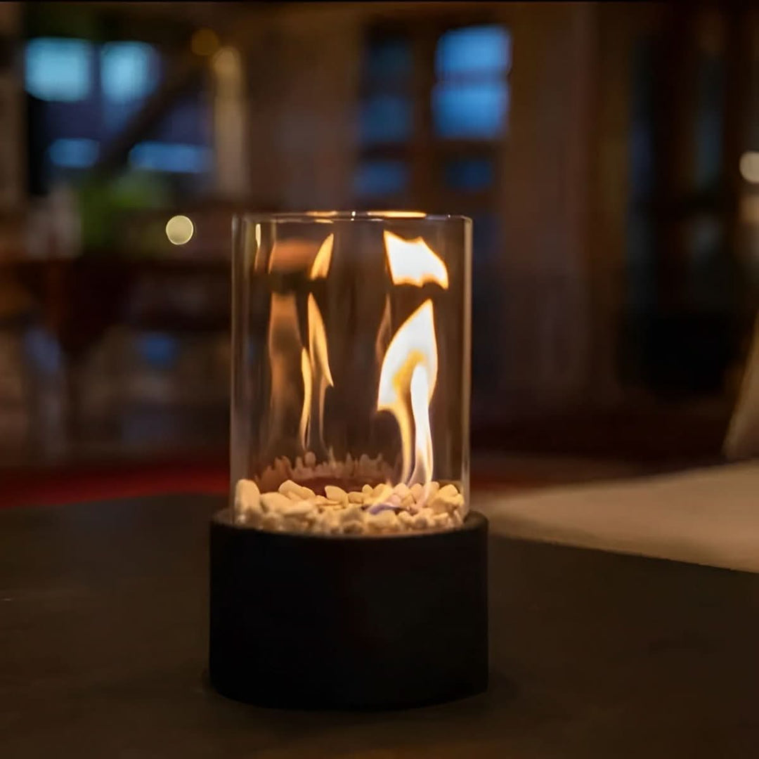 Modern black tabletop bioethanol fireplace burning brightly on a table