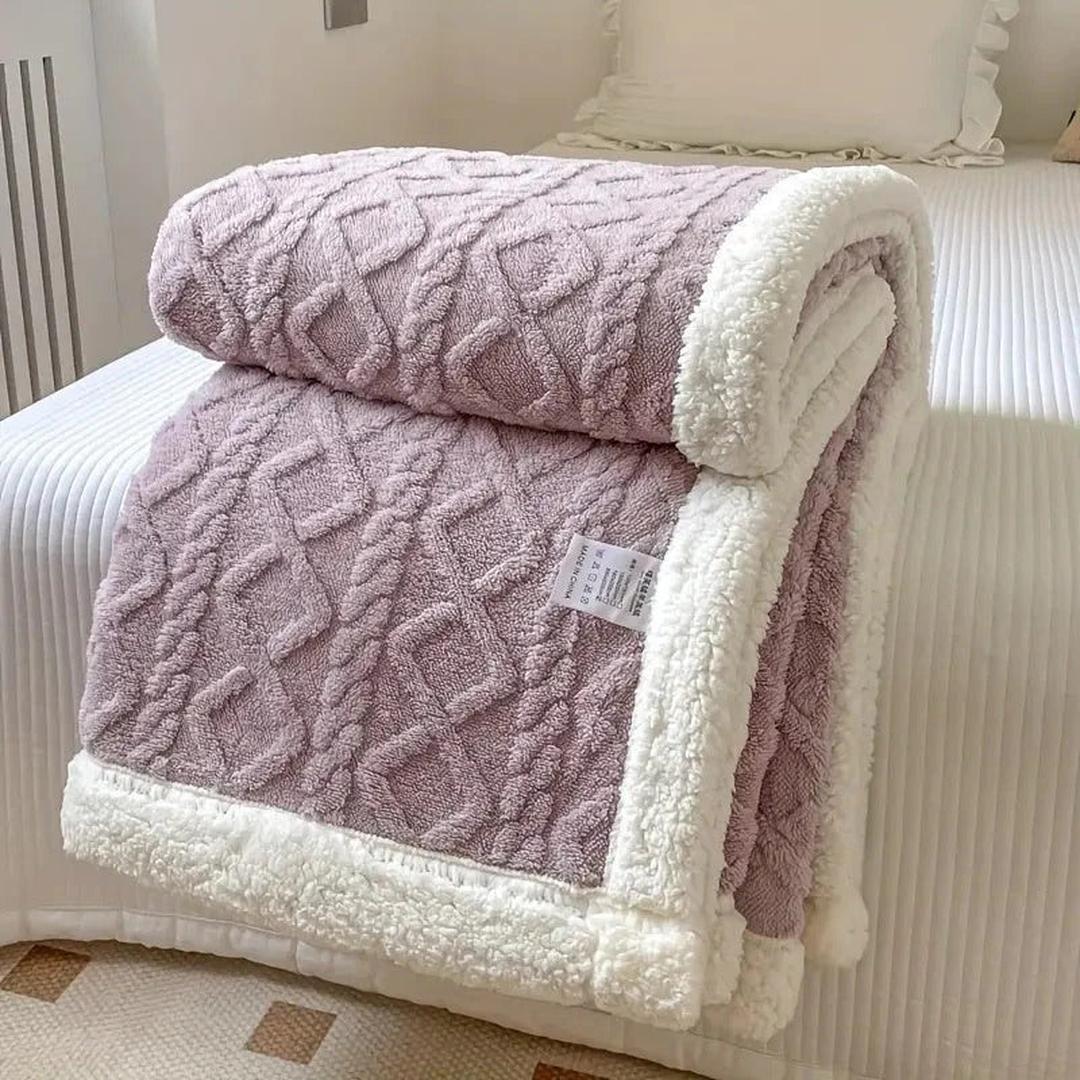 Warm bedding fleece blanket rolled up with a decorative ribbon