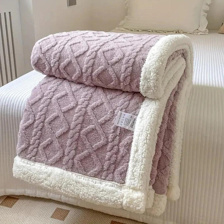 Warm bedding fleece blanket rolled up with a decorative ribbon