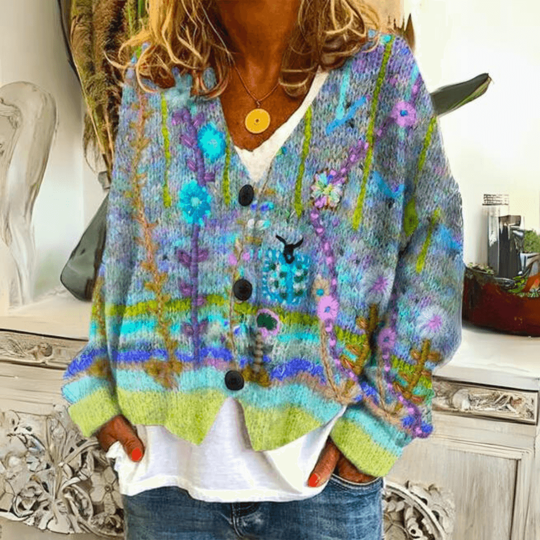 Close-up of green floral embroidered knit cardigan showcasing texture and button details
