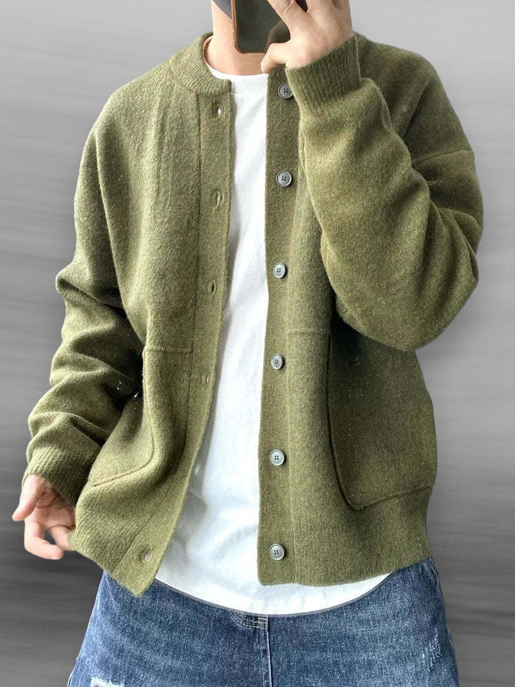 Man wearing an olive green knitted cardigan sweater with ribbed hem