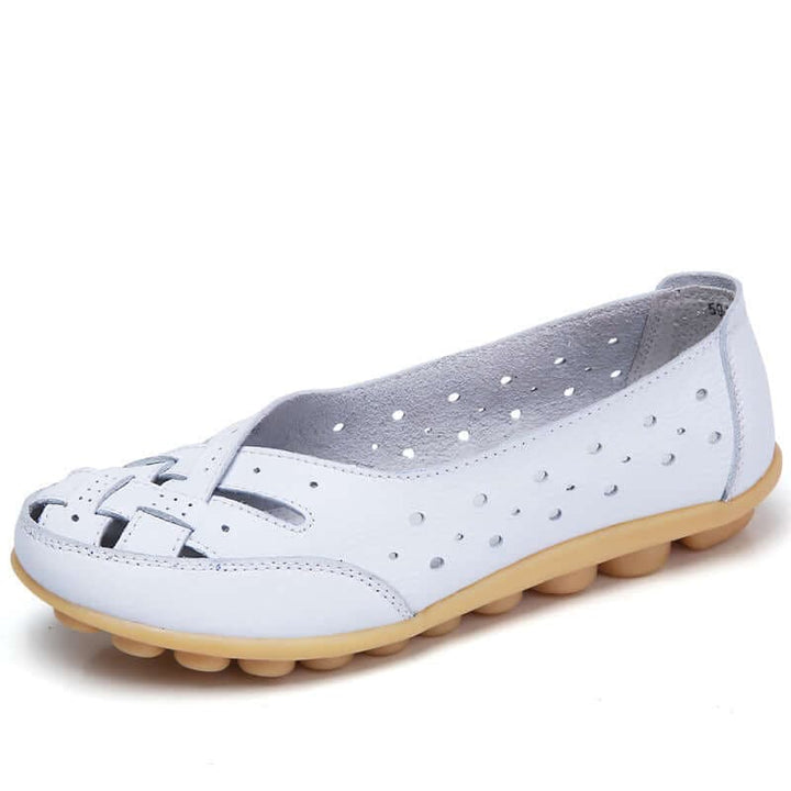 White women's soft cushioned flat shoe with perforated cutout design