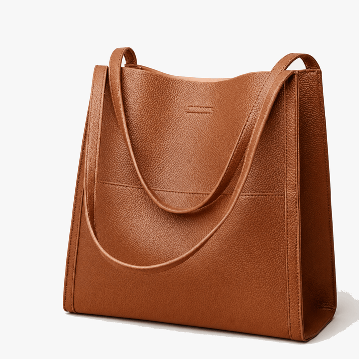 Women's soft shoulder tote bag in rich camel color showing structured base and dual handles