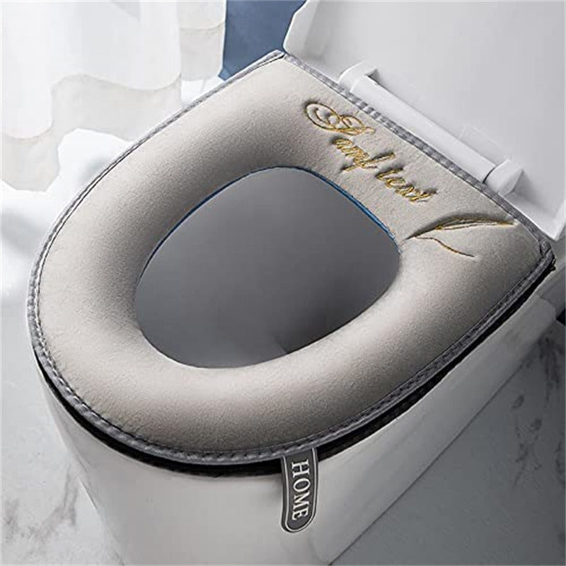Gray universal soft toilet seat cover installed on a white toilet bowl