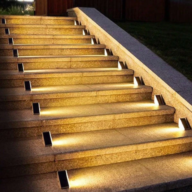 Solar stair lights illuminating outdoor stone steps at night