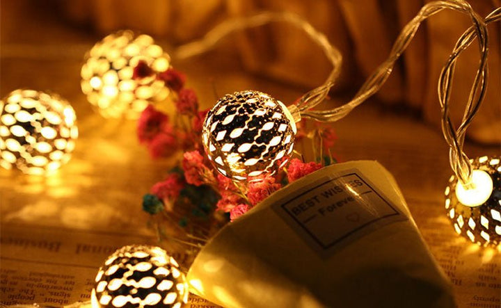 Close up of decorative metal lantern bulbs on solar garden garland