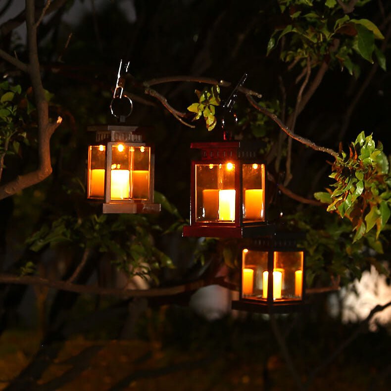 Close-up of solar hanging lanterns illuminating a dark garden evening