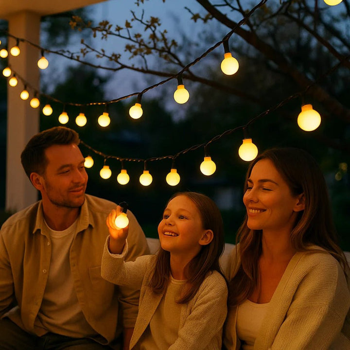 Family enjoying the cozy glow of outdoor solar fairy lights in the garden