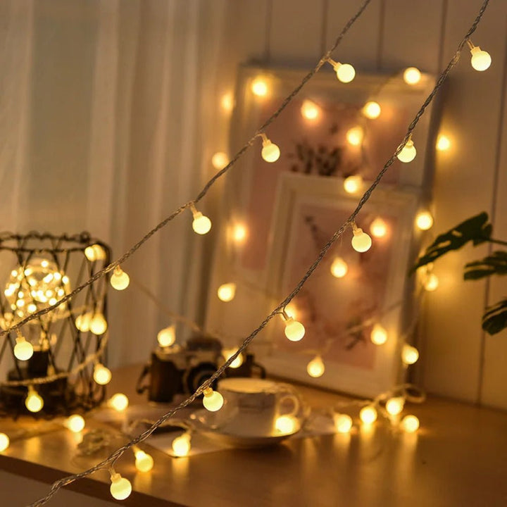 Weatherproof outdoor lighting string bulbs hanging on a patio pergola