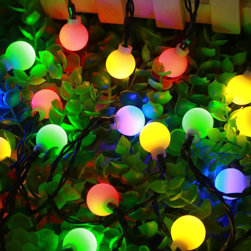 Close up of solar powered fairy lights glowing warmly in the garden