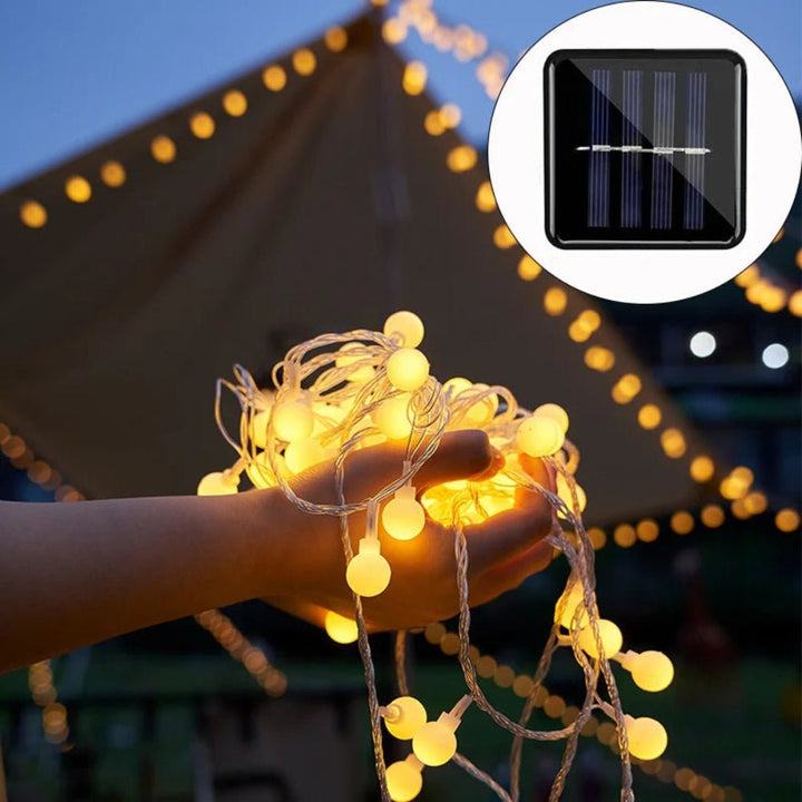 Close-up of solar panel and coiled waterproof LED fairy string lights