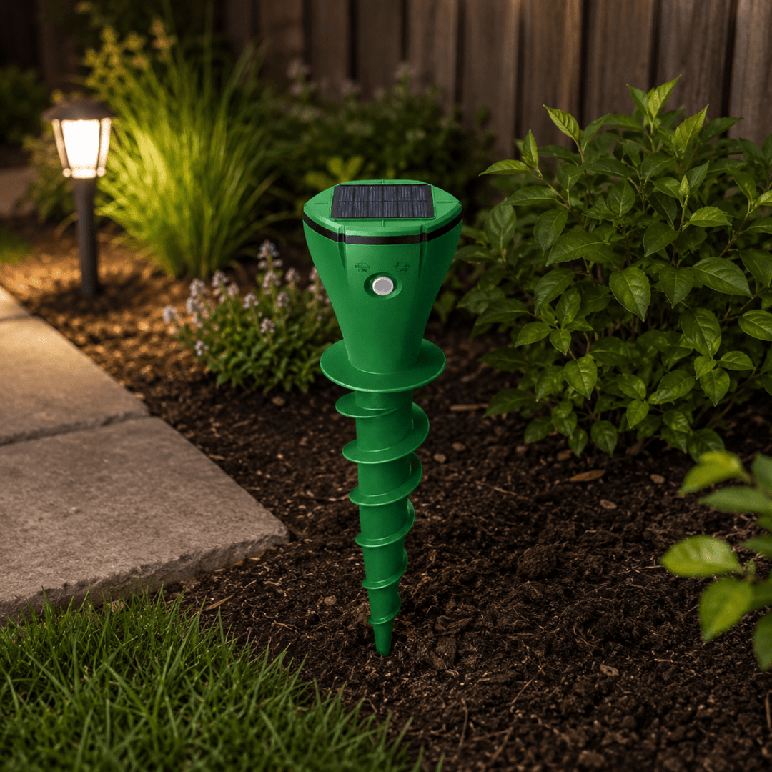 Close-up of the solar-powered landscape protection device near a garden pathway