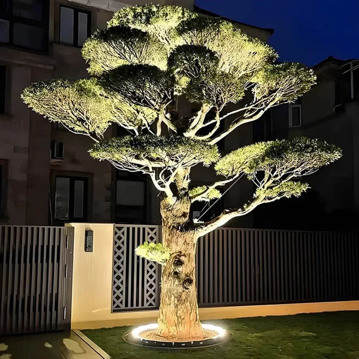 Adjustable solar LED tree spotlight illuminating garden foliage at night