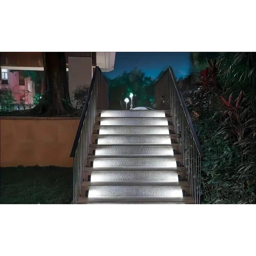 Outdoor stairway illuminated at night by bright white triangular solar lights