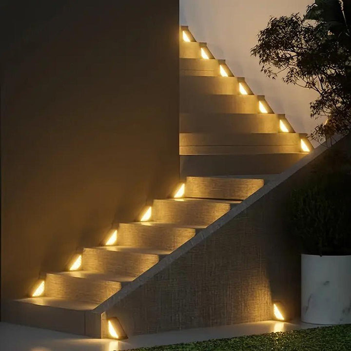 Outdoor staircase illuminated at night by warm yellow triangular solar lights