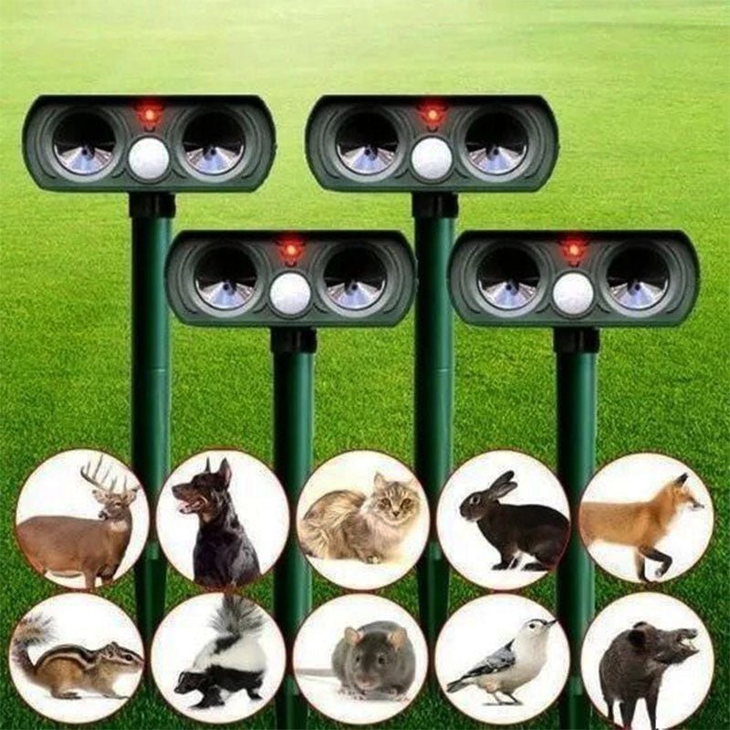 Solar powered ultrasonic animal repellers displayed against green grass with pest icons