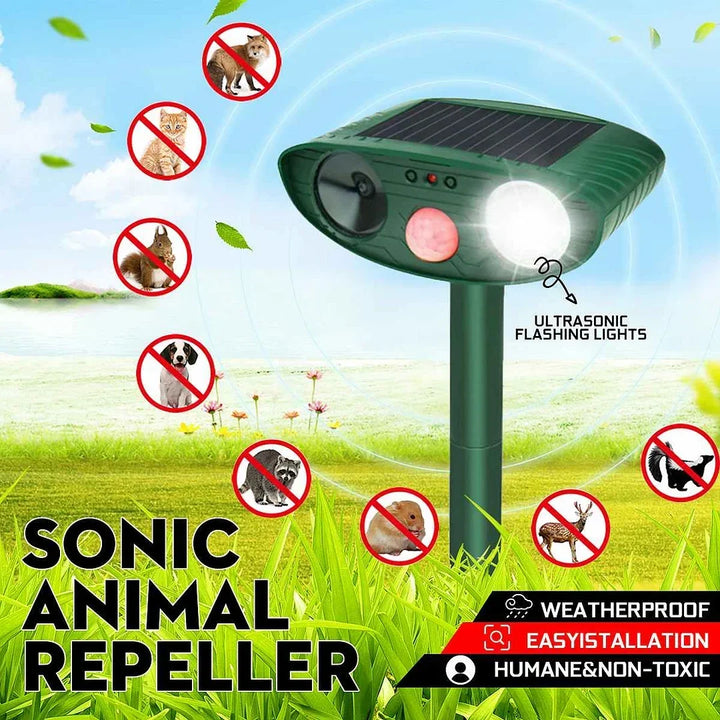 Solar animal repeller installed in a green lawn deterring various garden pests