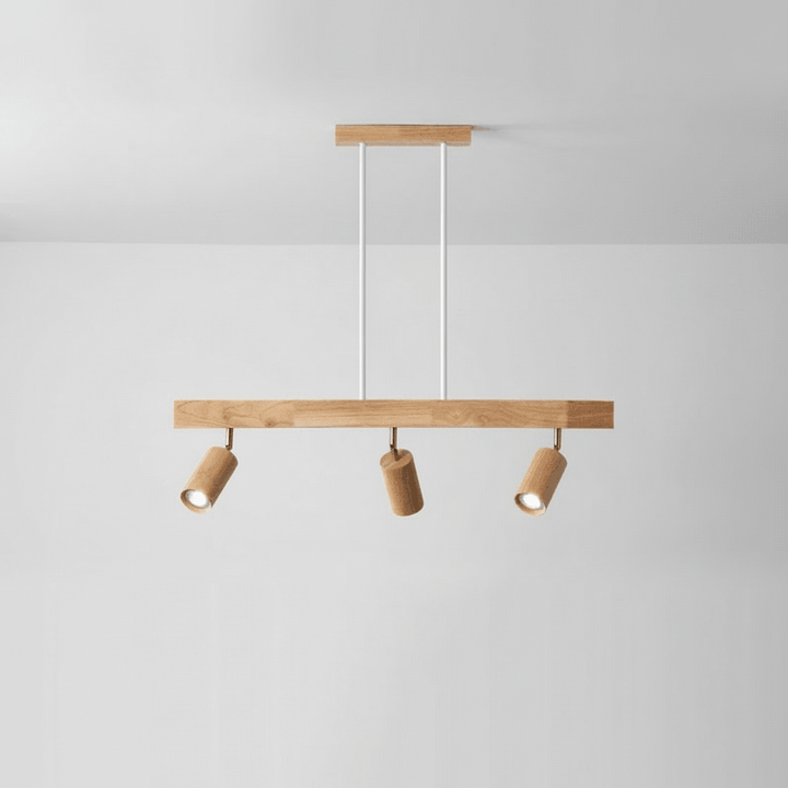 Multiple adjustable wooden spotlights mounted on a single track for layered lighting