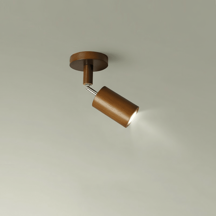 Single head solid wood LED ceiling spotlight glowing against a neutral wall