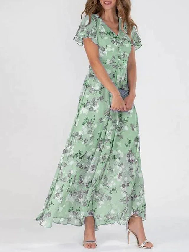 Woman wearing a green floral wrap maxi dress with V-neckline