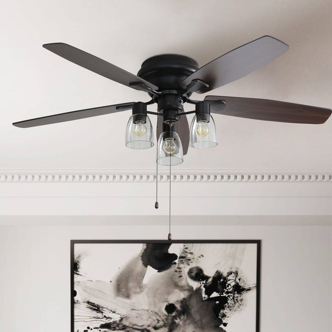 Close-up view of the black flush mount ceiling fan with glass light shades