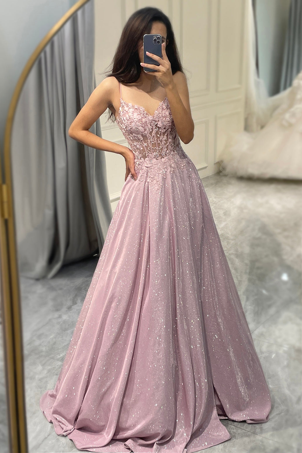 Full view of woman posing in sparkling blush pink evening dress