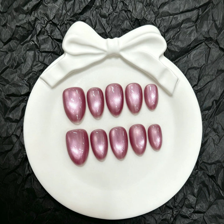 Glamorous pink press-on nails with sparkling glitter finish for a chic manicure look