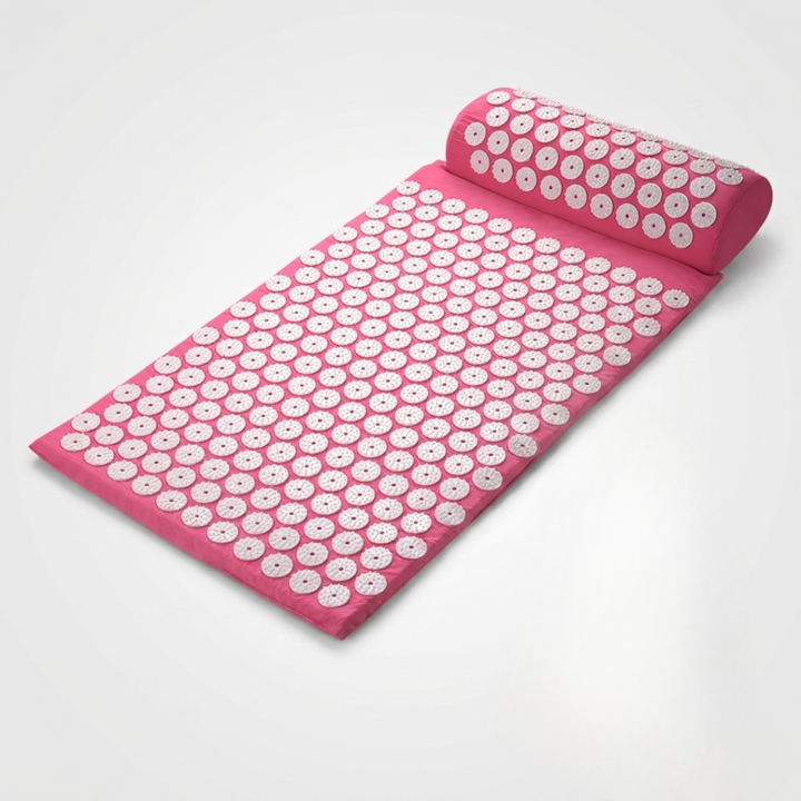 Close-up of plastic stimulation spikes on blue wellness acupressure massage mat for stress relief