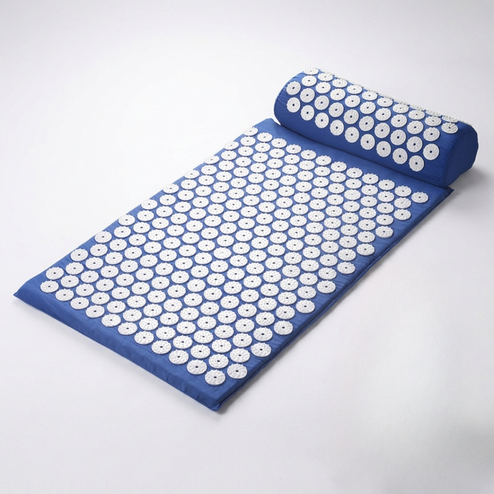 Rolled up portable acupressure therapy mat with carrying strap for easy wellness storage