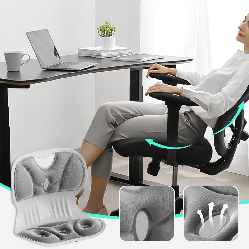 Person sitting at desk using ergonomic orthopaedic cushion