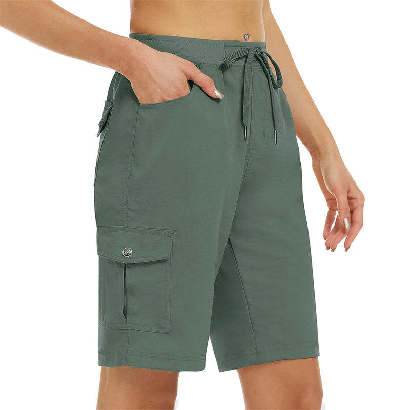 Flat lay composition of womens casual wear including cargo shorts and accessories