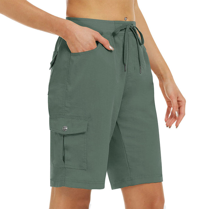 Flat lay composition of womens casual wear including cargo shorts and accessories