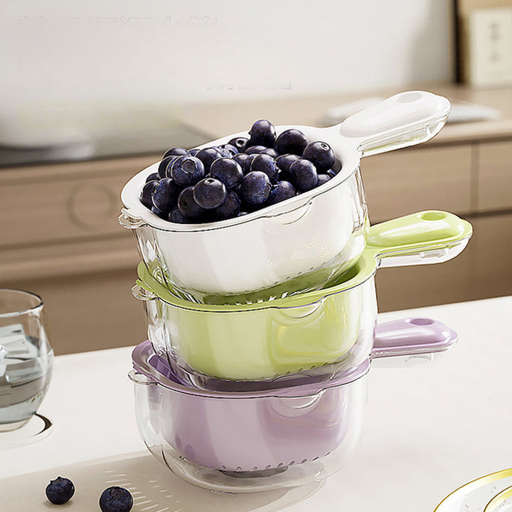 Stacked multi-colored kitchen double layer drainer baskets filled with fresh blueberries